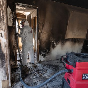 On the Spot Restoration technician repairing fire damage in home